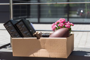 close-up shot of box with personal stuff of office worker after he gets fired clipart