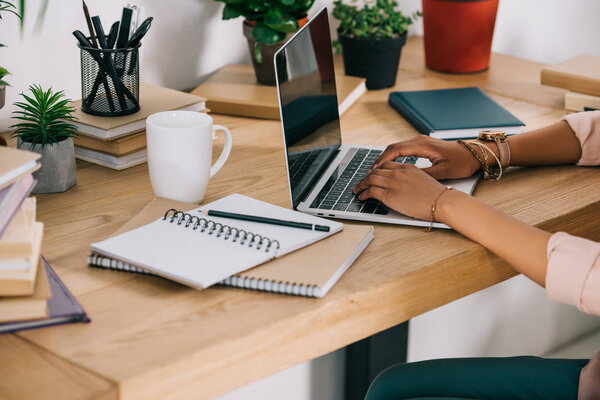 cropped image of african american businesswoman using laptop in office