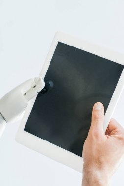 close-up view of human hand and robotic arm holding digital tablet with blank screen isolated on white clipart