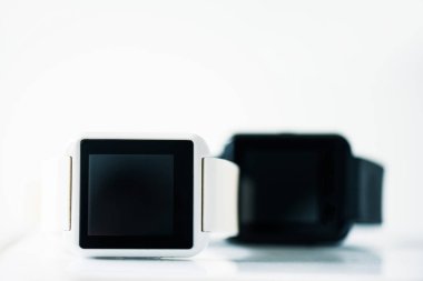 close-up view of smartwatches with black screens on grey    clipart