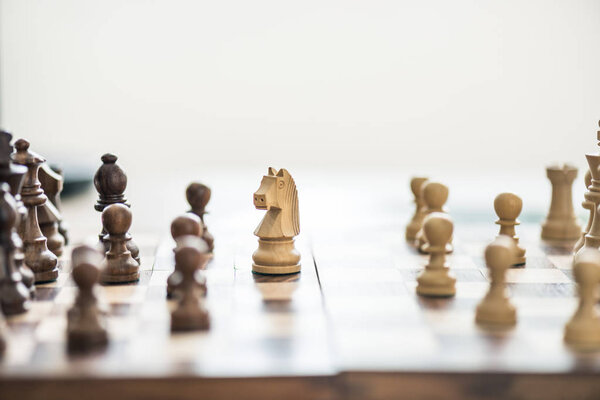 close-up view of wooden chess figures on chess board, selective focus