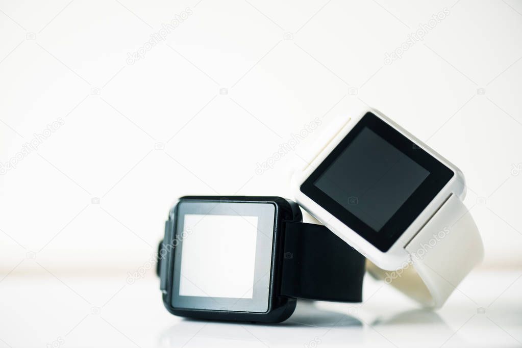 close-up view of smartwatches with blank screens on grey  