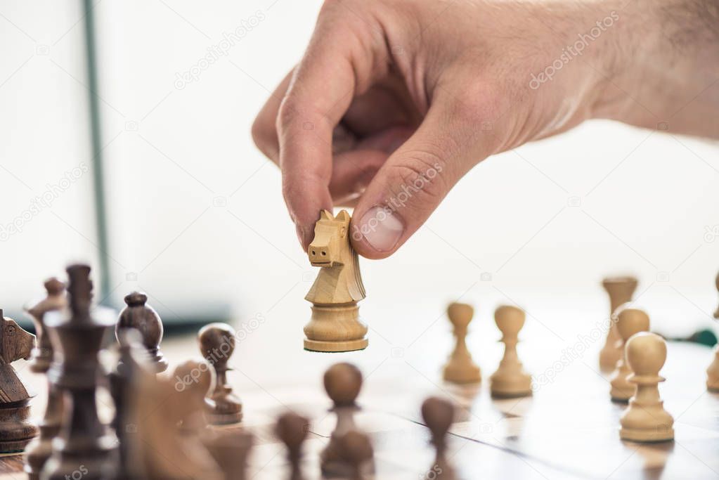 cropped shot of person playing chess, selective focus