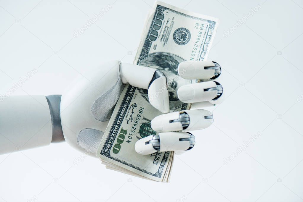 close-up view of robot holding dollar banknotes isolated on white 