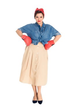 beautiful pin up woman in boxing gloves standing with hands on waist and looking at camera isolated on white clipart