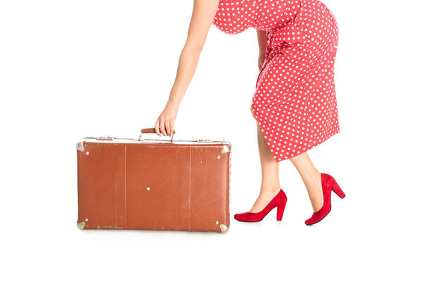 cropped shot of woman holding vintage suitcase isolated on white