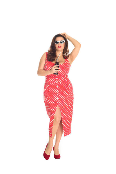 beautiful plus size woman in dress and vintage sunglasses with bottle of soda isolated on white