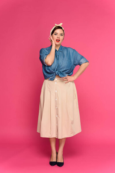 full length view of beautiful size plus pin up model looking at camera isolated on pink