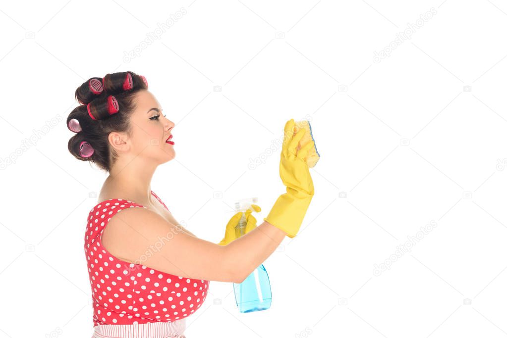 side view of plus size woman in rubber gloves with cleaning supplies wiping blank space isolated on white