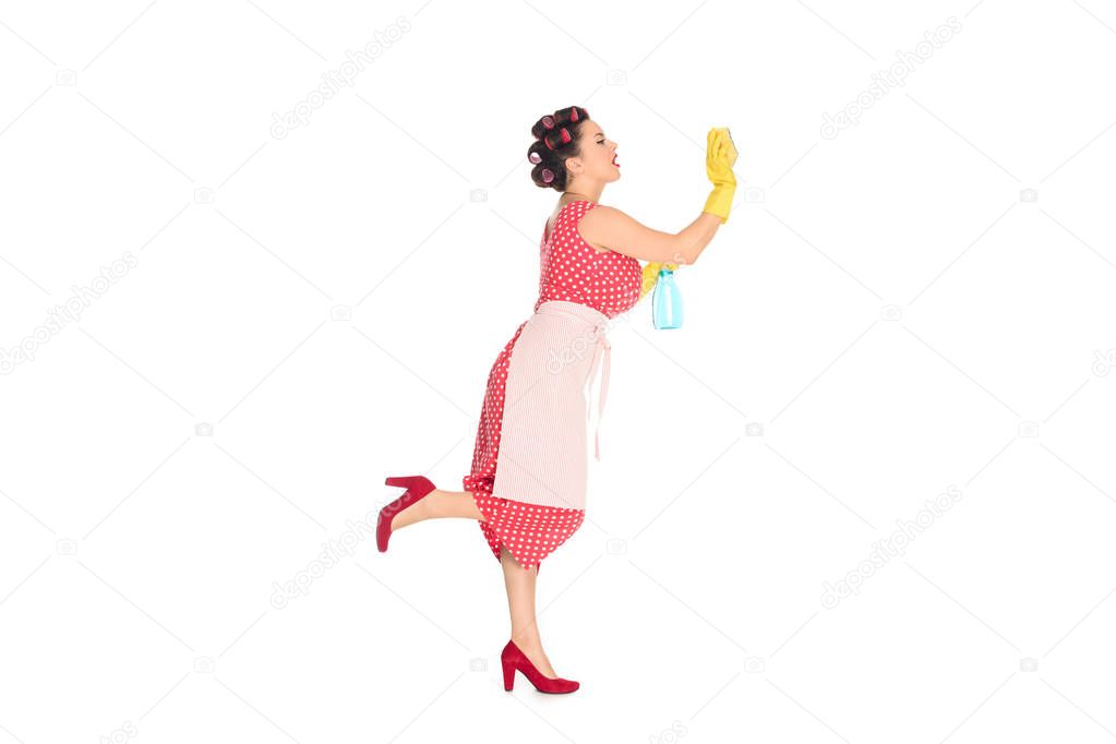 attractive plus size woman in rubber gloves with cleaning supplies wiping blank space isolated on white