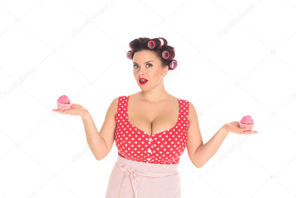 emotional plus size woman with pink cream cupcakes isolated on white