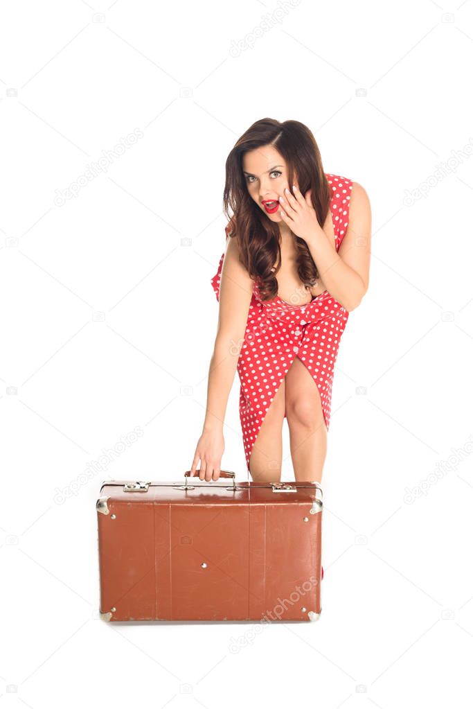 shocked plus size woman with vintage suitcase looking at camera isolated on white