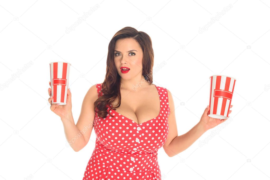 excited plus size woman in red dress with popcorn boxes isolated on white
