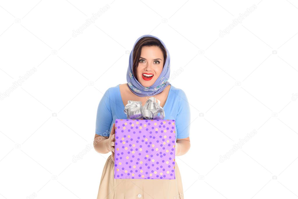 surprised happy vintage woman holding gift box and smiling at camera isolated on white