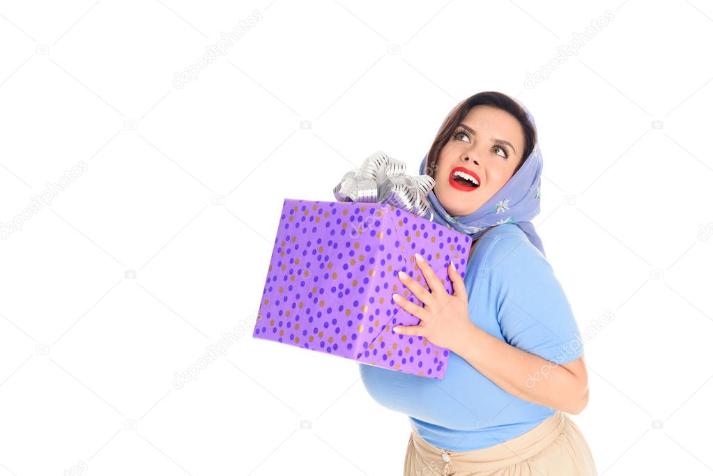 surprised happy woman holding gift box and looking up isolated on white