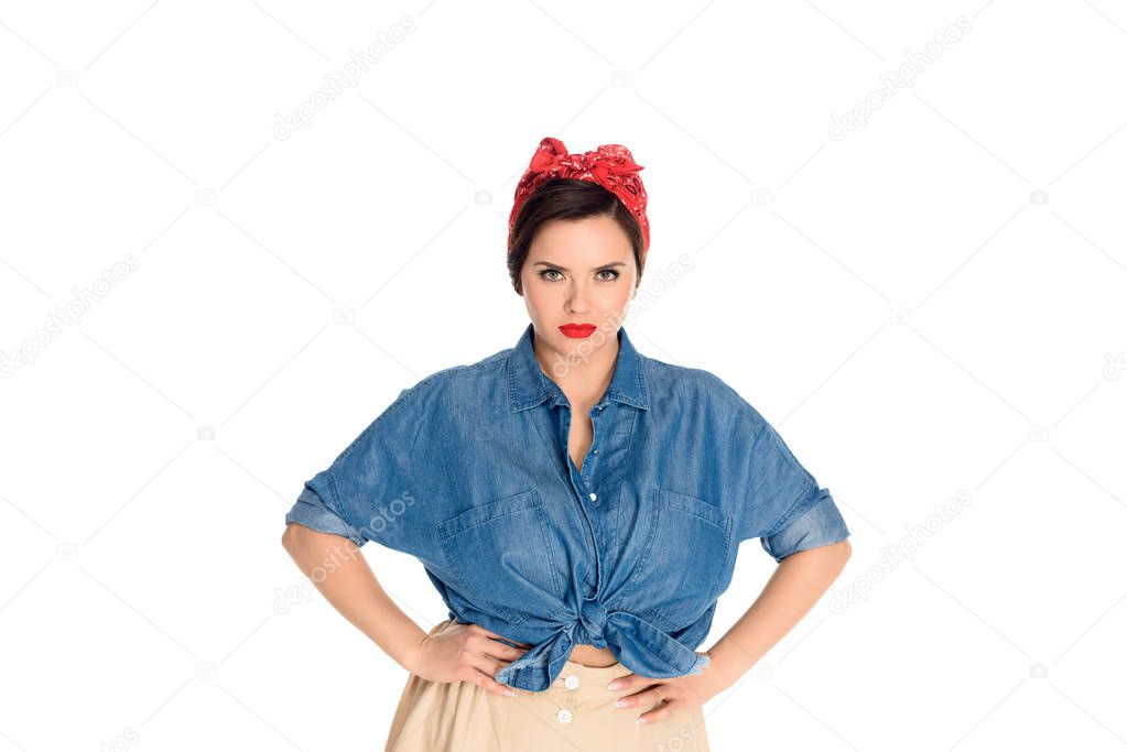 young  size plus pin up woman standing with hands on waist and looking at camera isolated on white 