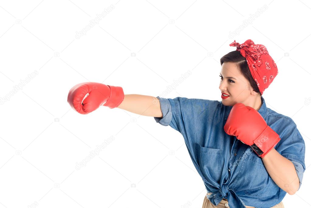 attractive size plus woman in boxing gloves hitting isolated on white