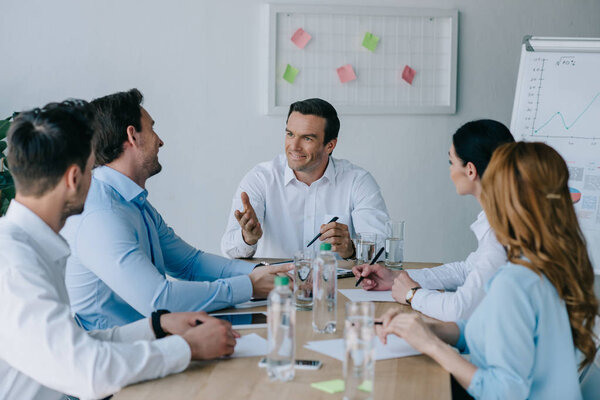 business colleagues having discussion at workplace in office