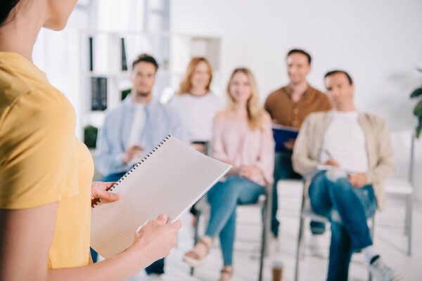 selective focus of business people listening to female mentor during business training