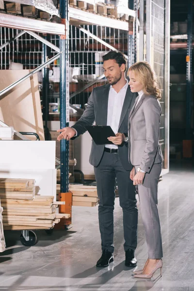 Handsome Businessman Pointing Finger Construction Materials While Standing Businesswoman — Stock Photo, Image