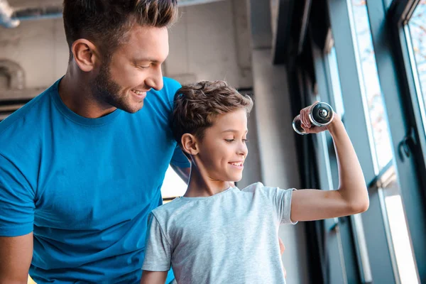Happy Father Looking Cheerful Son Exercising Dumbbell — Stock Photo, Image