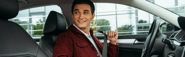 Smiling Young Man Holding Safety Belt Car Panoramic Shot — Stock Photo, Image