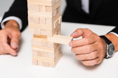 Takım elbiseli işadamının tahta bloklar oynadığı görüntüler. 