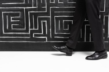 cropped view of businessman in formal wear walking near labyrinth  clipart