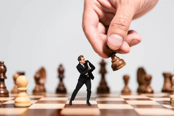 Cropped View Man Playing Chess Frightened Marionette Looking Figure Isolated — Stock Photo, Image