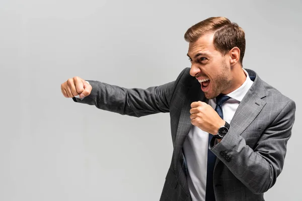 Angry Handsome Businessman Suit Punching Isolated Grey — Stock Photo, Image