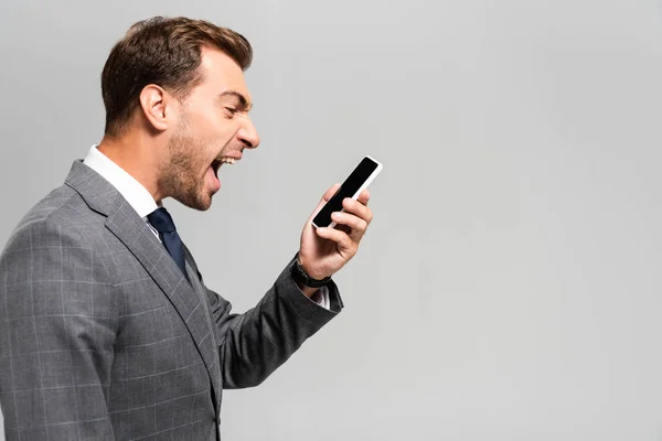 Side View Handsome Angry Businessman Suit Shouting Smartphone Isolated Grey — Stock Photo, Image