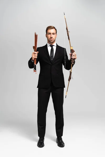 Handsome Businessman Suit Holding Bow Arrows Grey Background — Stock Photo, Image