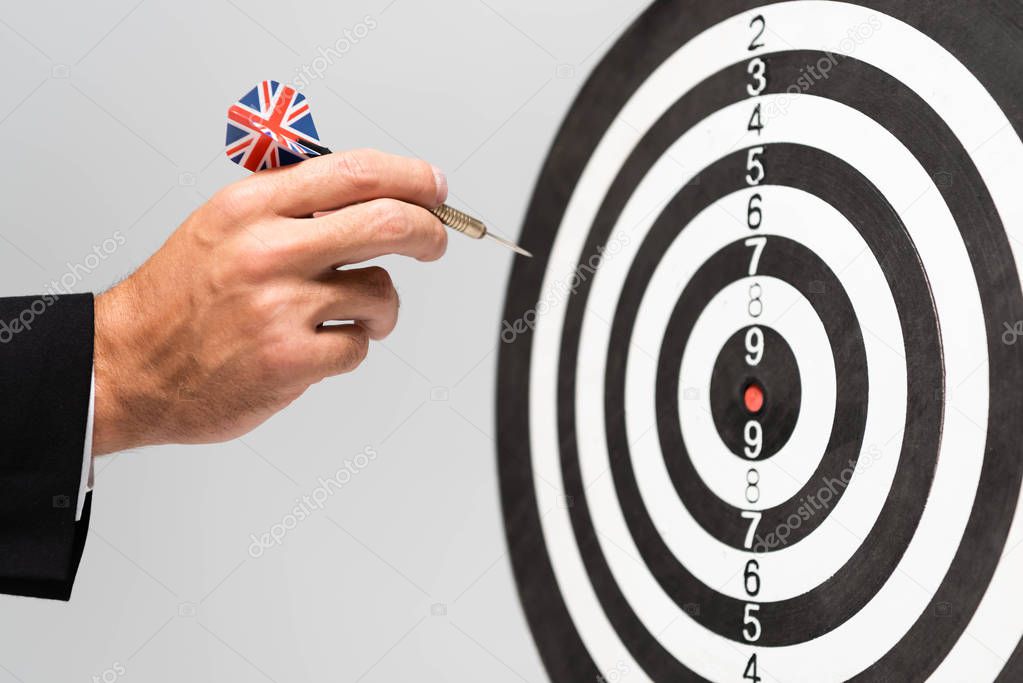 cropped view of businessman playing darts isolated on grey