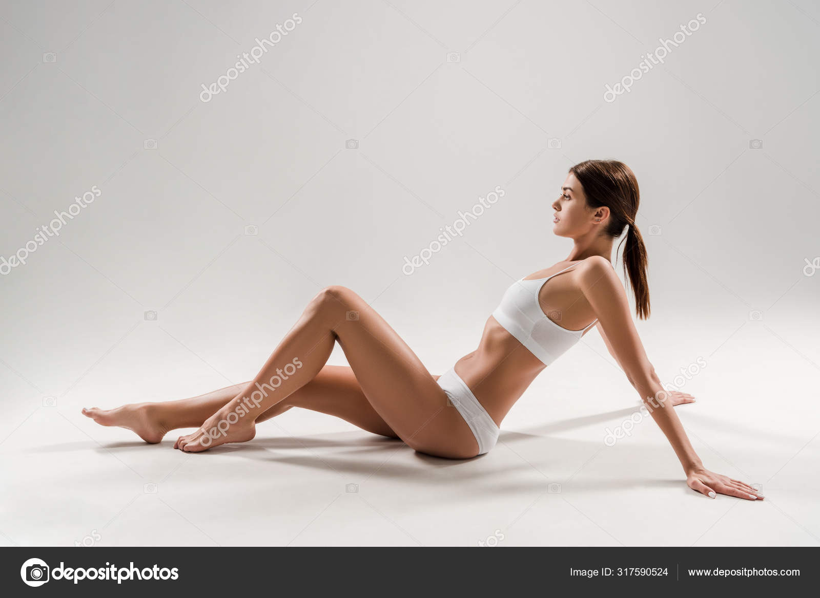 Side View Beautiful Slim Woman Underwear Sitting Grey Background Stock  Photo by ©IgorVetushko 317590524