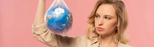 Panoramic Shot Blonde Woman Looking Globe Polyethylene Pack Isolated Pink — ストック写真