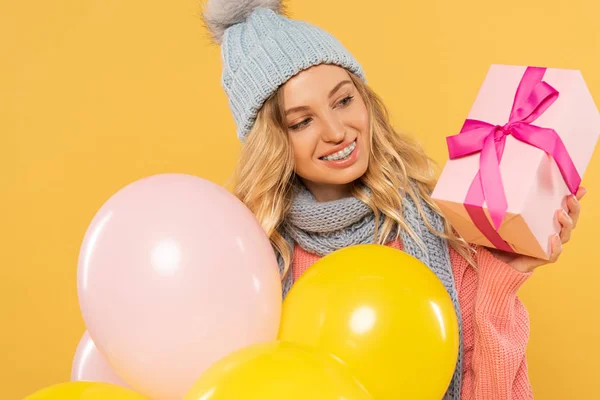 Smiling Woman Hat Scarf Holding Balloons Looking Gift Box Isolated — ストック写真