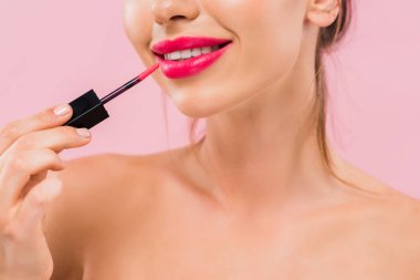 Çıplak gülümseyen, pembe dudaklı, pembe dudak parlatıcısı sürmüş güzel bir kadın görüntüsü. 