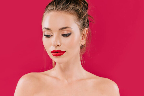 naked beautiful woman with red lips looking away isolated on red