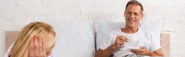 Panoramic Shot Man Drinking Coffee Looking Wife Bed — Stock Photo, Image