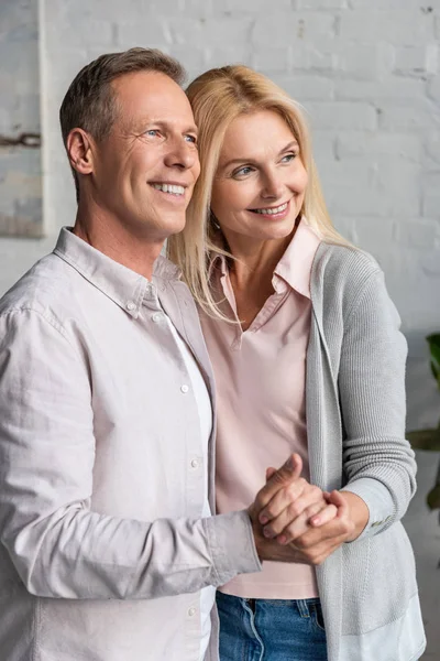 Smiling Mature Couple Holding Hands Dancing Home — Stock Photo, Image