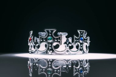 antique silver crown with gemstones on black clipart