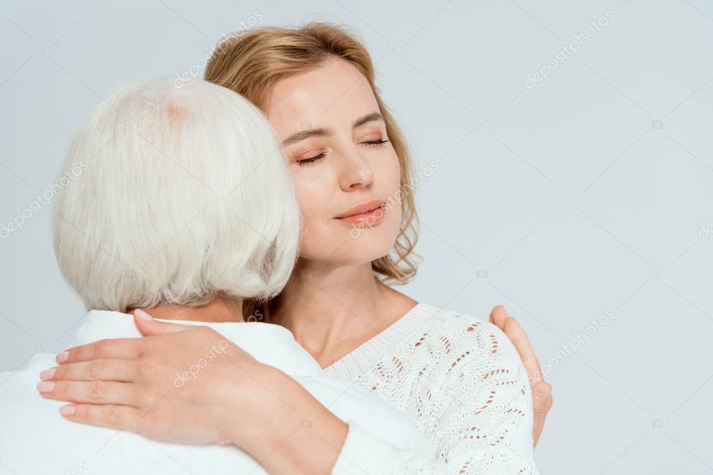 back view of mother hugging attractive daughter isolated on grey 