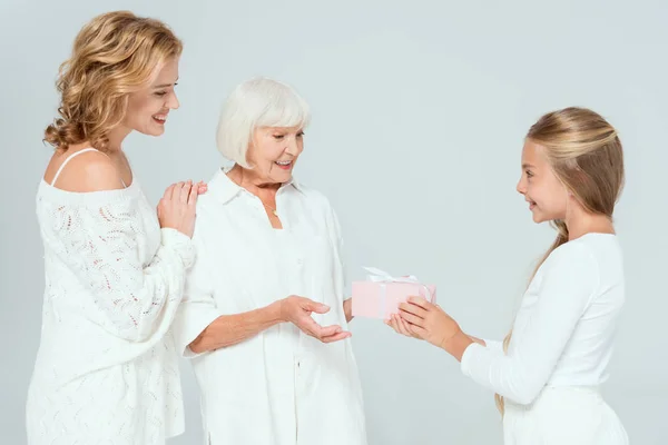 Smiling Granddaughter Giving Gift Grandmother Isolated Grey — Stock Photo, Image