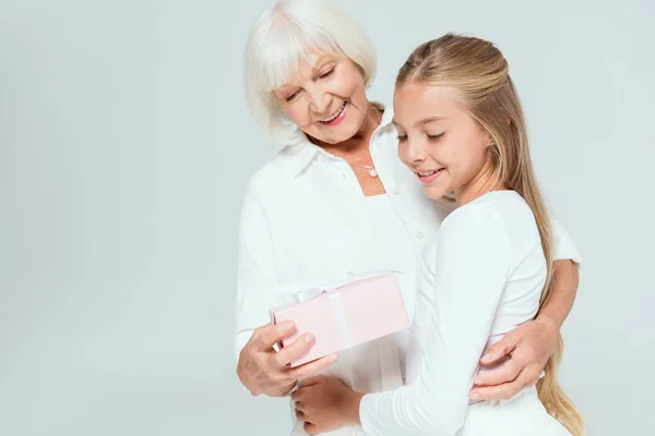 Smiling Granddaughter Grandmother Looking Present Isolated Grey — Stock Photo, Image