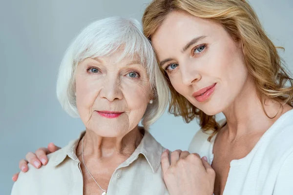 Daughter Hugging Mother Looking Camera Isolated Grey — Stock Photo, Image