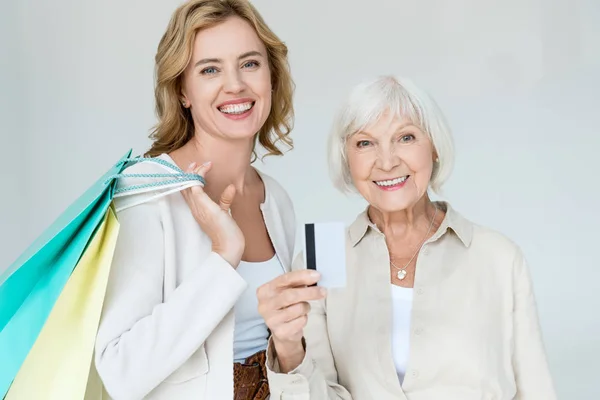 Smiling Mother Credit Card Daughter Holding Shopping Bags Isolated Grey — Stock Photo, Image