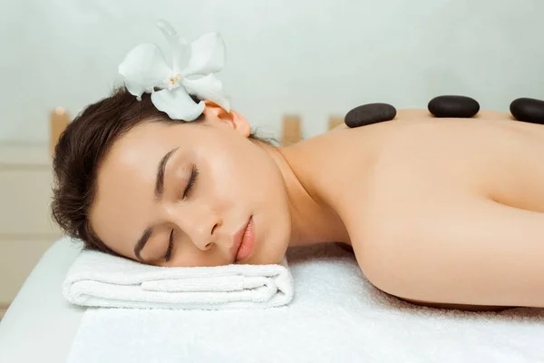 Mulher Atraente Com Pedras Quentes Nas Costas Deitado Mesa Massagem — Fotografia de Stock