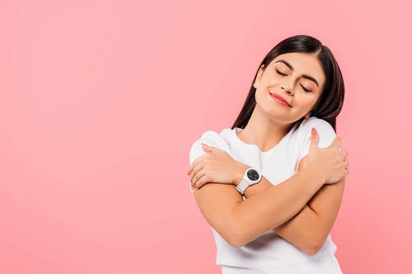 Smiling Pretty Brunette Girl Hugging Herself Closed Eyes Isolated Pink — ストック写真