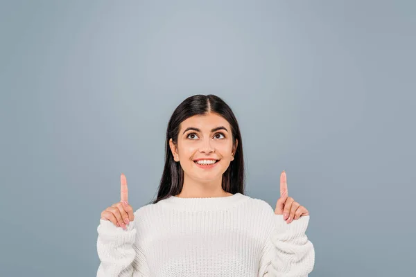 Smiling Pretty Brunette Girl White Sweater Pointing Fingers Upwards Isolated — Stock Photo, Image