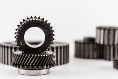 selective focus of metal round gears on white background clipart